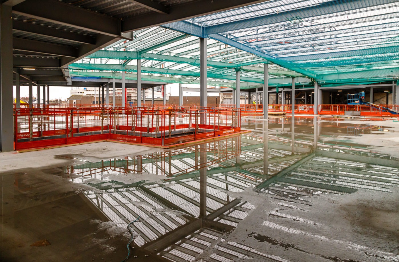 Arndale Centre Eastbourne construction site rainbow colours reflected in puddles